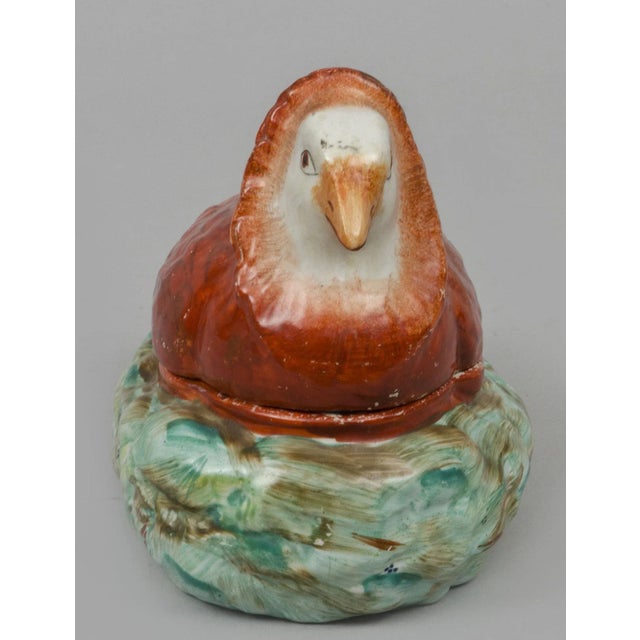 English Staffordshire style small pearlware tureen in the form of a turtle dove resting on a nest. It is decorated in...