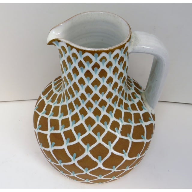 Vintage studio pottery ewer from Danish company Ioska (also referred to as Joska). The piece has been hand-painted with a...