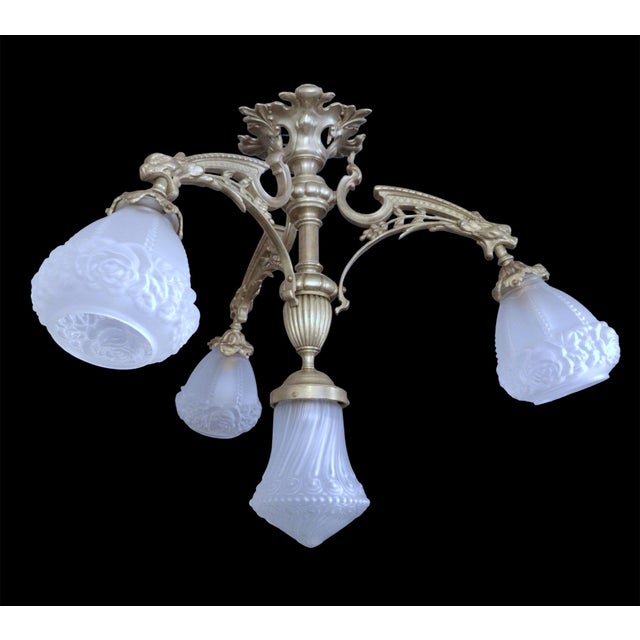 French 19th Century bronze four-light antique chandelier, neo gothic style, gryphons, mascarons, gargoyles. This antique...