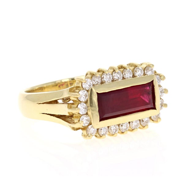 This ring has a straight Baguette Cut Ruby that weighs 2.56 Carats and 20 Round Cut Diamonds that weigh 0.58 Carats with a...