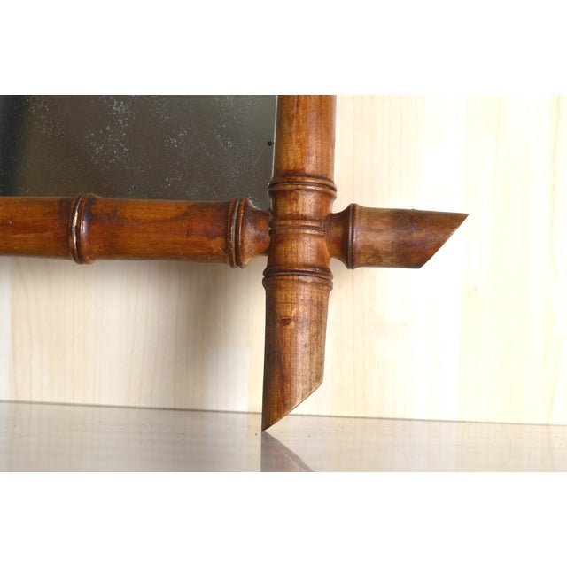 This charming antique French wall mirror features an elegant faux bamboo frame, reflecting the refined and playful...