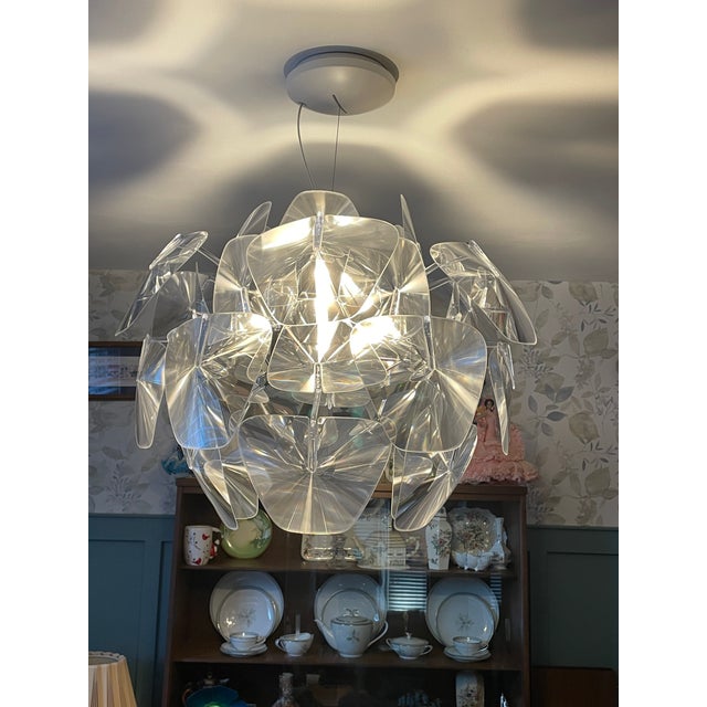 This light fixture is the Luceplan Hope Pendant Light, a modern interpretation of the traditional crystal chandelier....