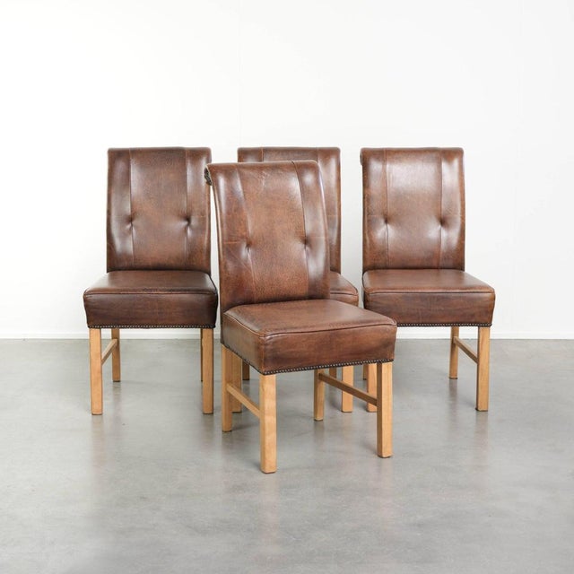 This set of 4 sheepskin dining chairs features a dark cognac color and an English-style look. A dining chair is more than...