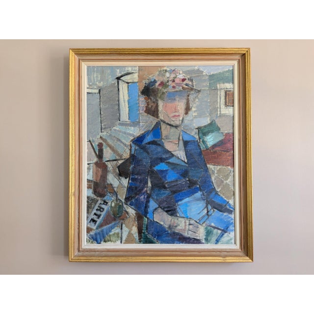 WOMAN IN A BLUE COAT Size: 29.5 x 25.2 inches (including frame) Oil on canvas A compelling mid-century modern figurative...