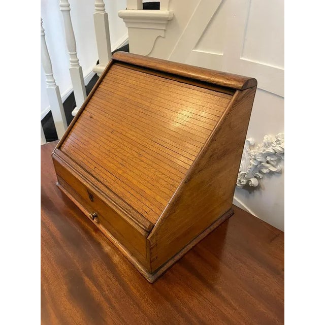 Unusual antique oak stationery cabinet with a sliding tambour front opening to reveal a fitted interior, original brass...