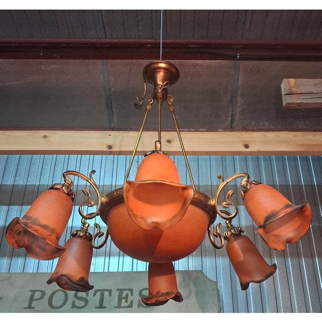 Pair of Art Nouveau Bronze and Orange Glass Paste Chandeliers A remarkable pair of Art Nouveau chandeliers in bronze with...