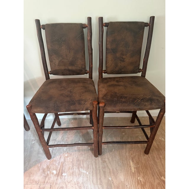 Offered is a rare, matching pair of authentic upholstered barstools from the iconic "Old Faithful" collection by the Old...