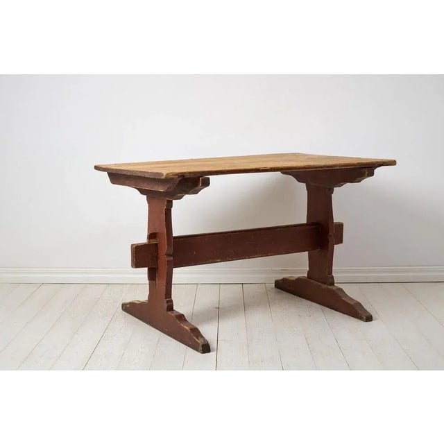 Antique rustic dining table or work table from northern Sweden, made around 1820. The table has a frame in solid pine...