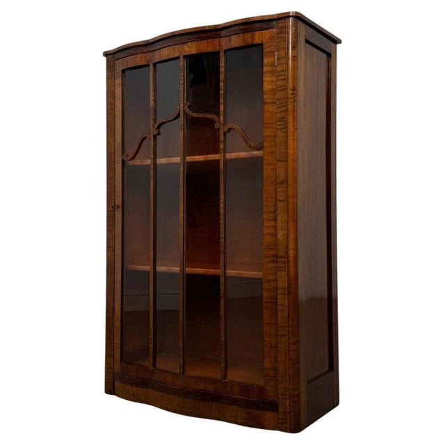 A striking and beautifully crafted 20th-century Art Deco style display cabinet, distinguished by its richly figured...