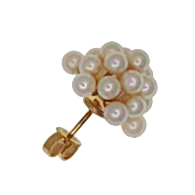 Estate pearl cluster earrings. These estate earrings are crafted in 14 karat yellow gold featuring a cluster of 3mm pearls...