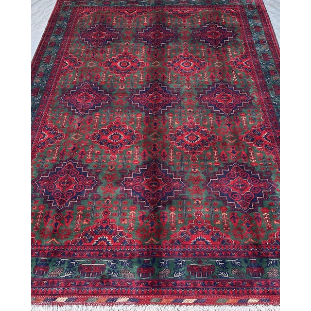 Forest green is an unusual ground color for an Afghan Turkmen rug — most collectors see it and stop. The field of this...