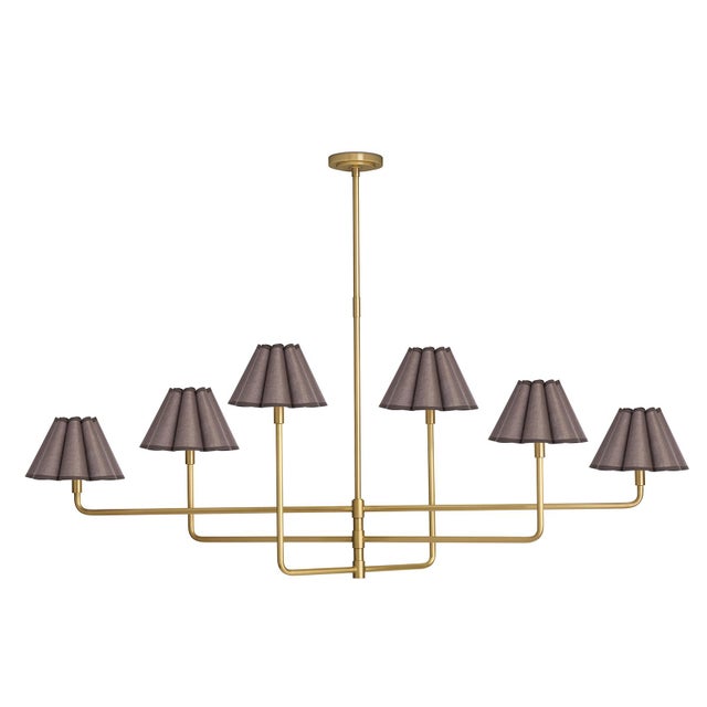 The Polly Chandelier embodies grace and versatility with its six shades, delicately crafted from umber linen and sewn into...