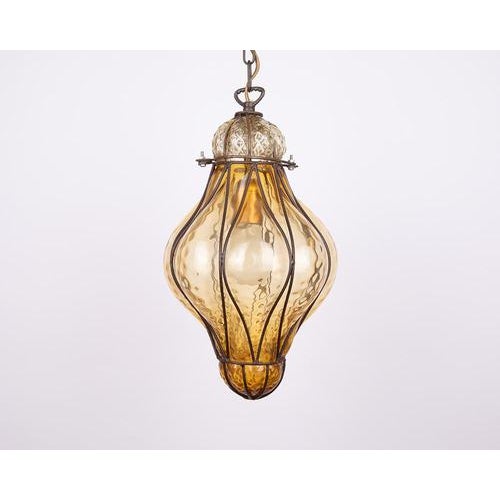 Illuminate your space with the rare beauty of the amber seguso murano caged glass pendant light from the 1960s. Expertly...