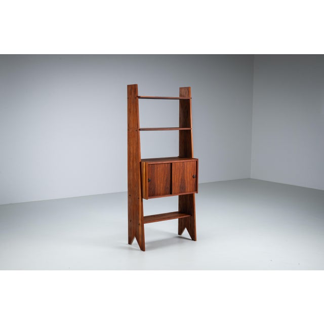 This distinctive bookcase, sourced in Italy, is a striking example of thoughtful craftsmanship and sculptural design,...