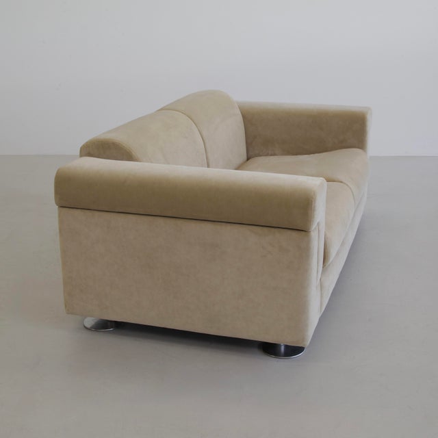 Sofa upholstered in sand coloured velvet designed by Tecno's Borsani and Bonetti in 1966. Polished metal feet appear...