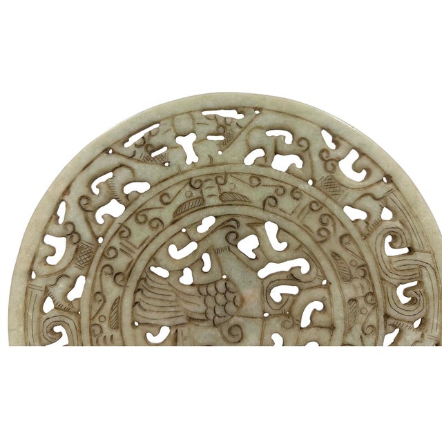 This item is a decorative Chinese openwork jade Bi disc featuring intricate carvings of dragons and phoenixes symbol on...