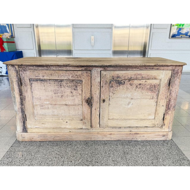 This antique Swedish credenza was hand-crafted in the 19th Century from elm wood. The elegance of the woodwork, with its...