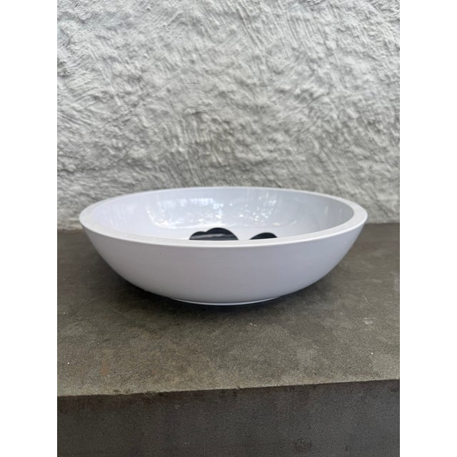 Large severing bowl made of melamine with Marimekko’s icon flora design in the center of the bowl. The manufacturer’s mark...