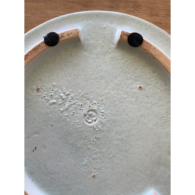 Beautiful and heavy, this mid-size polychrome serving platter/trivet/wall plate features a recurring French blue...