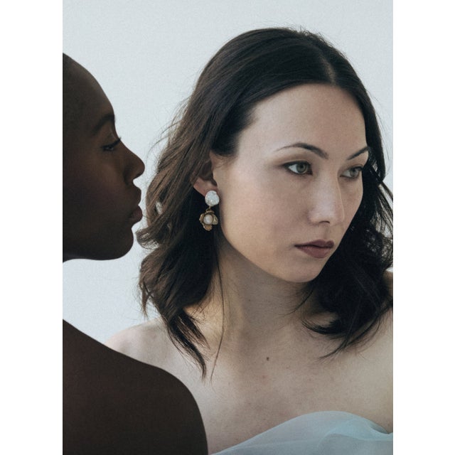 The matching set of the Ivory Earrings are hand-carved flowers, set with freshwater pearl studs. They are lightweight and...