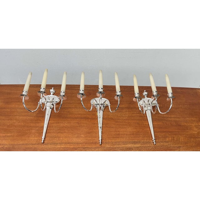 Elegant wall sconces from Italy in neoclassical and Hollywood Regency styles. This set consists of three wall sconces in a...