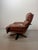 Comfortable swivel lounge chair by Leolux, featuring cognac brown leather upholstery and a sculptural bentwood frame. A...