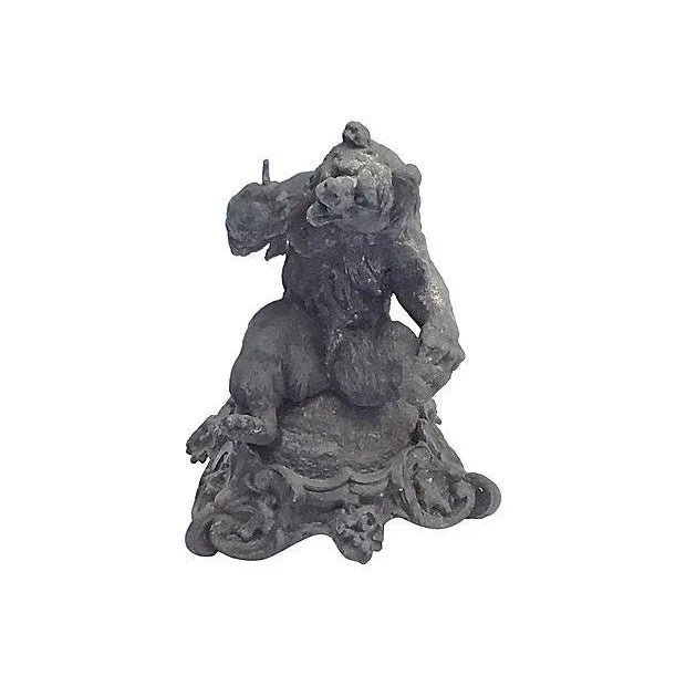 Antique; 19th century, English, cast iron, bear figurine sitting on a stylized acanthus leaf base. No maker's mark....