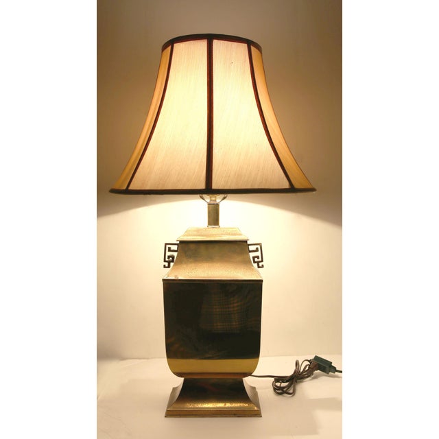 Mid-Century Hollywood Regency Chinoiserie Brass Table Lamp with Greek Key Handles Sculptural and elegant, this mid-20th-...
