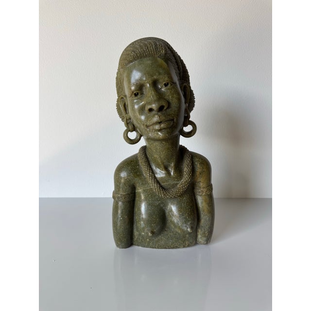 A striking vintage hand-carved African woman bust sculpture crafted from richly mottled verdite stone and signed Cashel K....