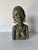 A striking vintage hand-carved African woman bust sculpture crafted from richly mottled verdite stone and signed Cashel K....