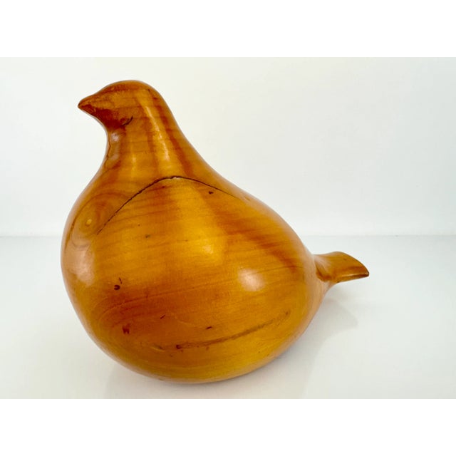 This mid-century modern bird sculpture is crafted from a warm, honey-toned wood, showcasing its natural grain and smooth...