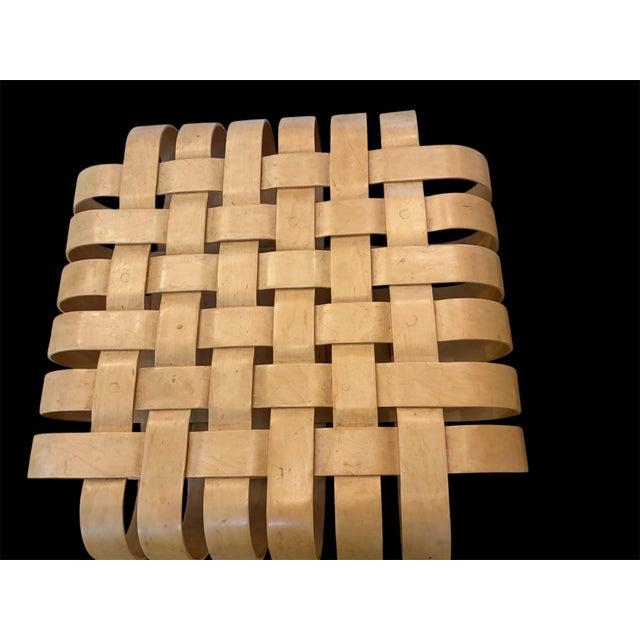 Armchair and ottoman from the iconic “Power Play” series designed by Frank Gehry for Knoll, dated 1993. This sculptural...