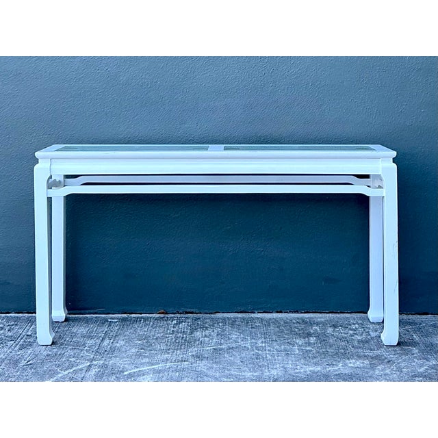 This elegant Ming-style console table is a masterful fusion of ancient Eastern design and 20th-century Hollywood Regency...