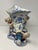 Antique German Rococo-Revival figural porcelain spill vase. Blue and white floral painting, with dotted cobalt edging. A...