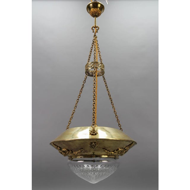 Antique French brass and bronze pendant light with cut glass lampshade from the circa 1900. This beautiful antique...