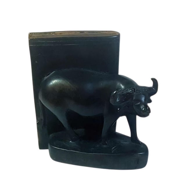 A characterful pair of carved wooden bookends, originating from an old library and designed as sculptural supports for...