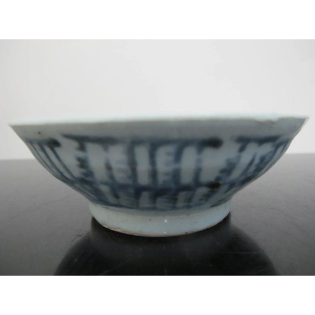 Small, rustic Chinese Ming style antique pottery bowl featuring a pale celadon or grayish-blue glaze with a distinctive...