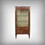 This three-sided display cabinet in mahogany and mahogany veneer, in the Louis XVI style, is a refined piece whose slender...