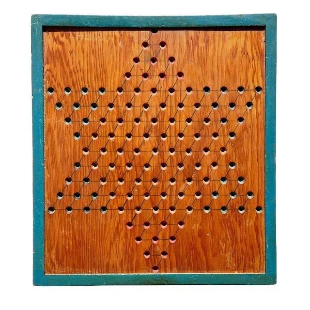 A solid wood antique Chinese Checkers game board. This piece is from Pennsylvania and was created in the early 1900s. It...