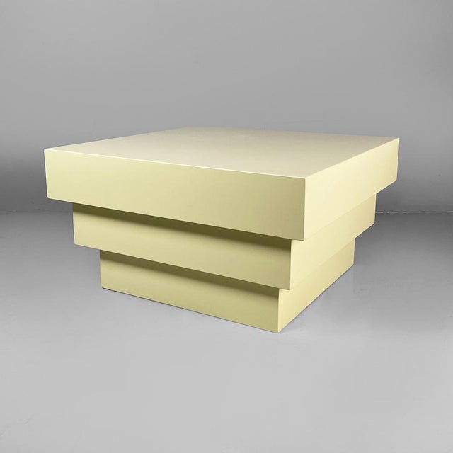 Italian modern coffe table or pedestal in light yellow wood, 1980s Pedestal or coffee table with a square top, made...