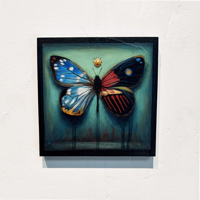 This artwork presents a striking representation of a butterfly, showcasing an intricate blend of vibrant colors and...