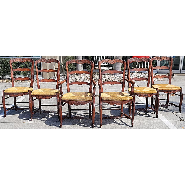 As solid and authentic 20th c. version of the classic French Country ladderback dining chair, a set of 4 side and 2...