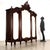 Late Baroque walnut wardrobe, tripartite front with doors and beveled mirrors. Scroll and leaf carvings on the base band...
