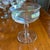 A set of vintage stemmed sherbet glasses with a soft iridescent finish that catches the light in pale pinks, golds, and...