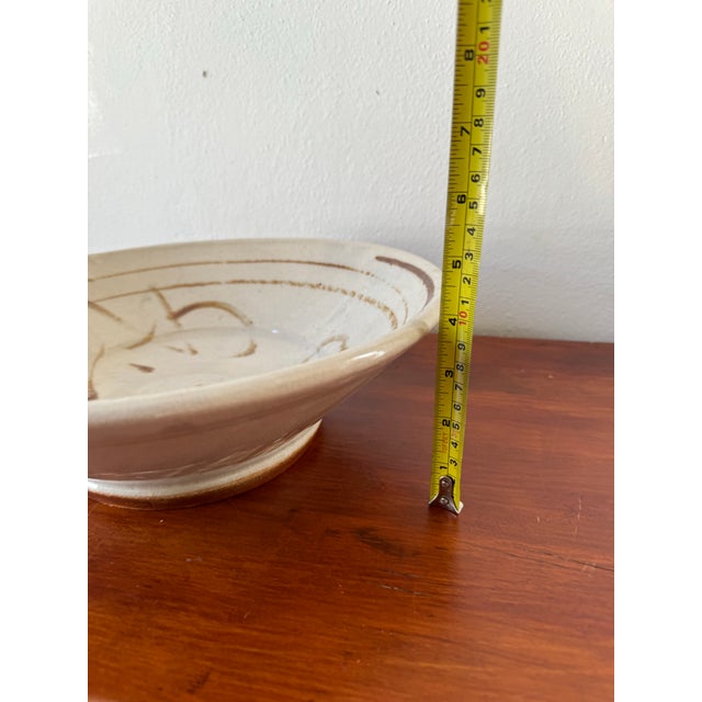 This neutral handmade bowl would be a lovely centerpiece or serving piece. Signed and dated on the bottom by the artist.