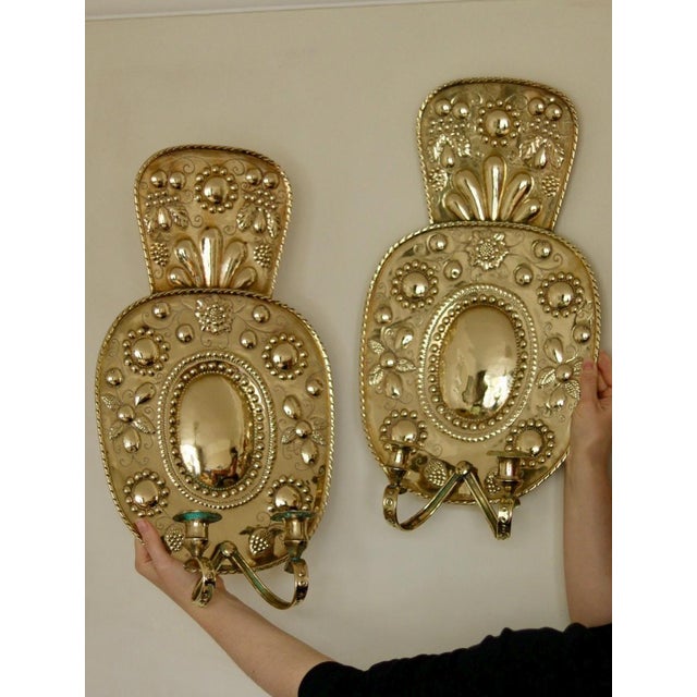 Made in Sweden A breath-taking mid-century duo of exquisite Swedish brass wall sconces, showcasing captivating hammered...