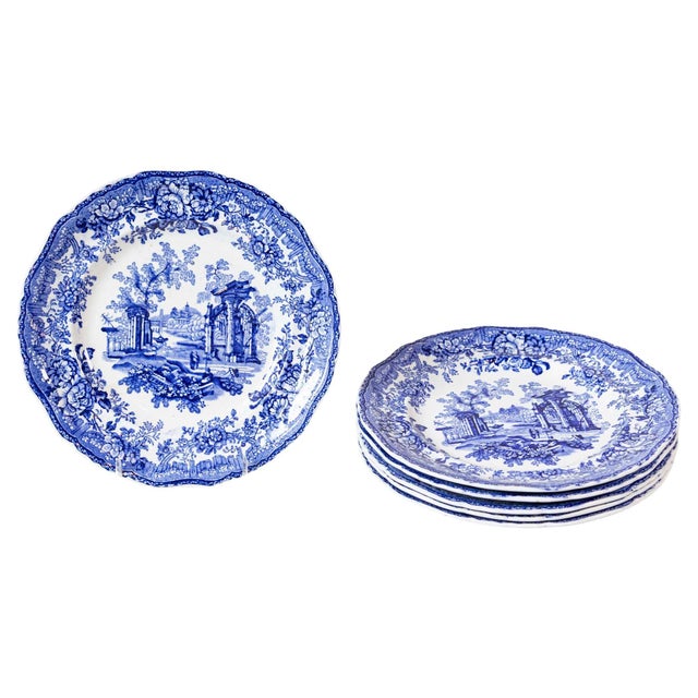 Six English blue and white transferware dinner plates from the 19th century, with classical ruins and floral motifs, sold...
