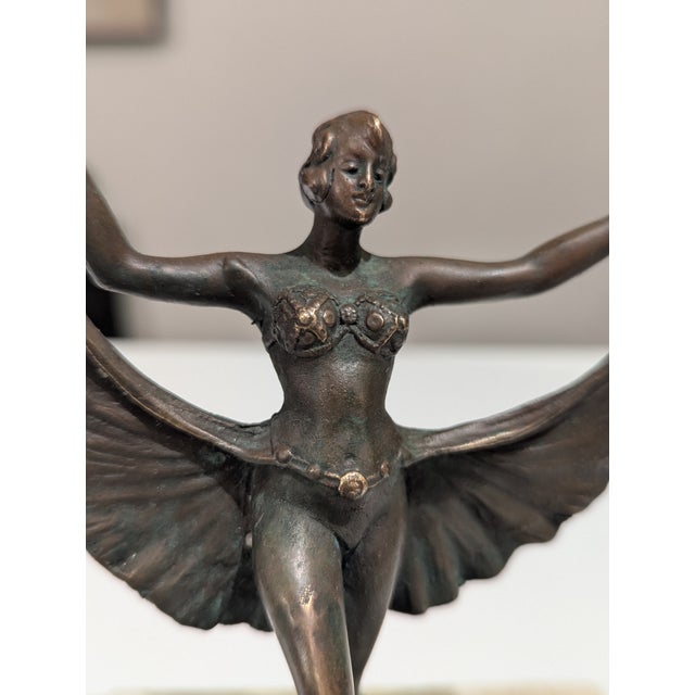 This Art Deco dancer is all about controlled motion. Balanced en pointe on a small bronze rug, the figure stretches...