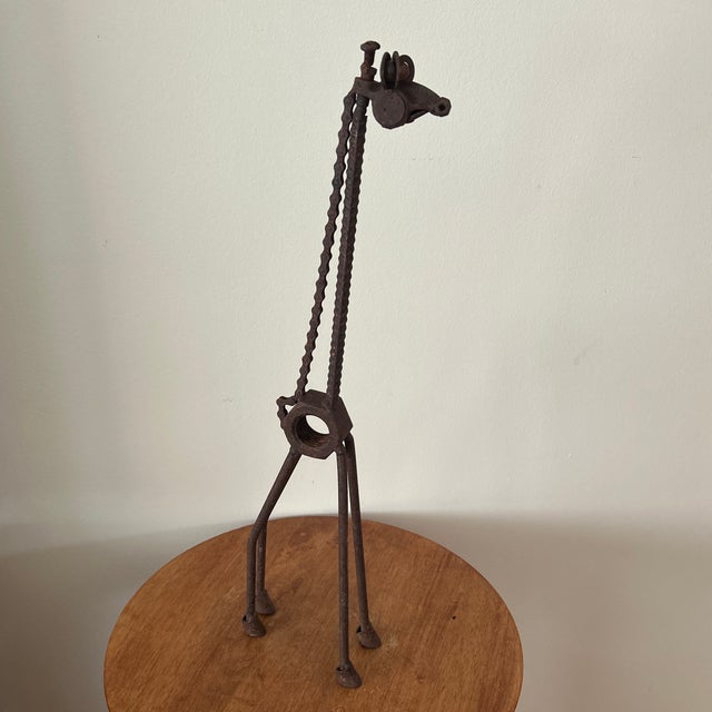This vintage iron whimsical handcrafted rusted giraffe sculpture is a charming addition to any room. Standing tall and...