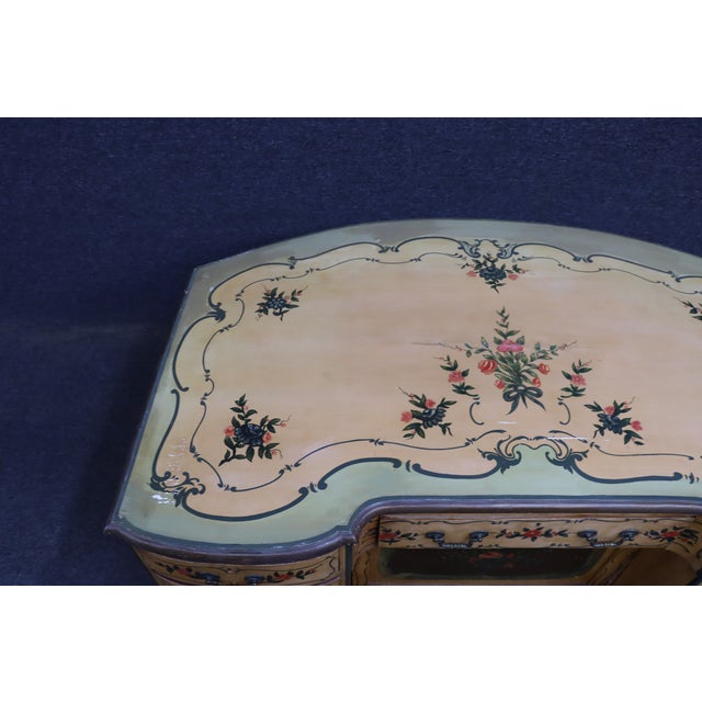 Decorative Italian Provincial kneehole desk featuring a cream-painted finish with hand-painted floral bouquets and...